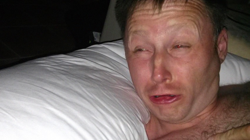 A man suddenly woken up in a dark room at night